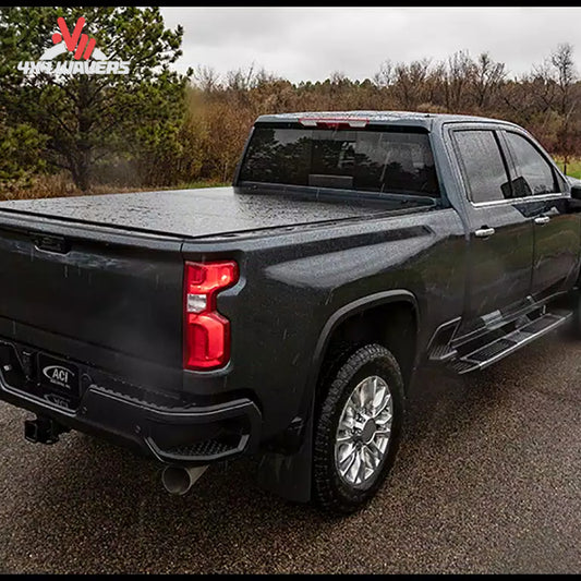 A black LOMAX Stance Hard Folding Tonneau Cover on a Ford F-150 with a 6.5-foot bed, installed on a pickup truck.