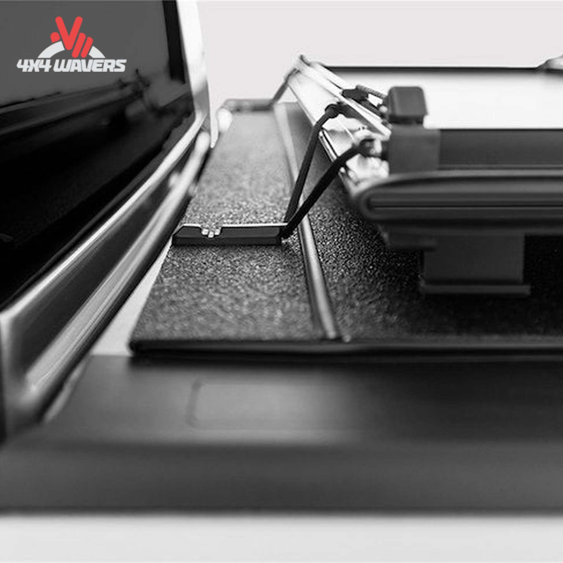 A black LOMAX Stance Tonneau Cover with tight bite clamp latch on a Ford F-150 5.5ft bed, installed on a pickup truck.