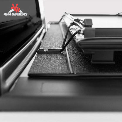 A black LOMAX Stance Tonneau Cover with tight bite clamp latch on a Ford F-150 5.5ft bed, installed on a pickup truck.