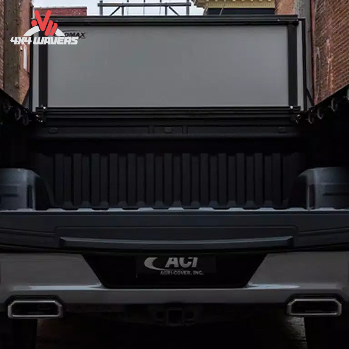 The hard folding tonneau cover locked securely in an upright vertical position away from the rear window glass.