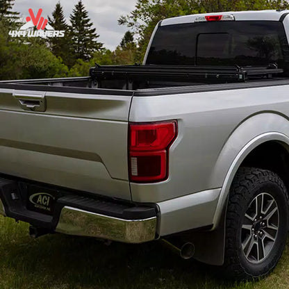 The hard folding tonneau cover locked securely in an upright vertical position away from the rear window glass.