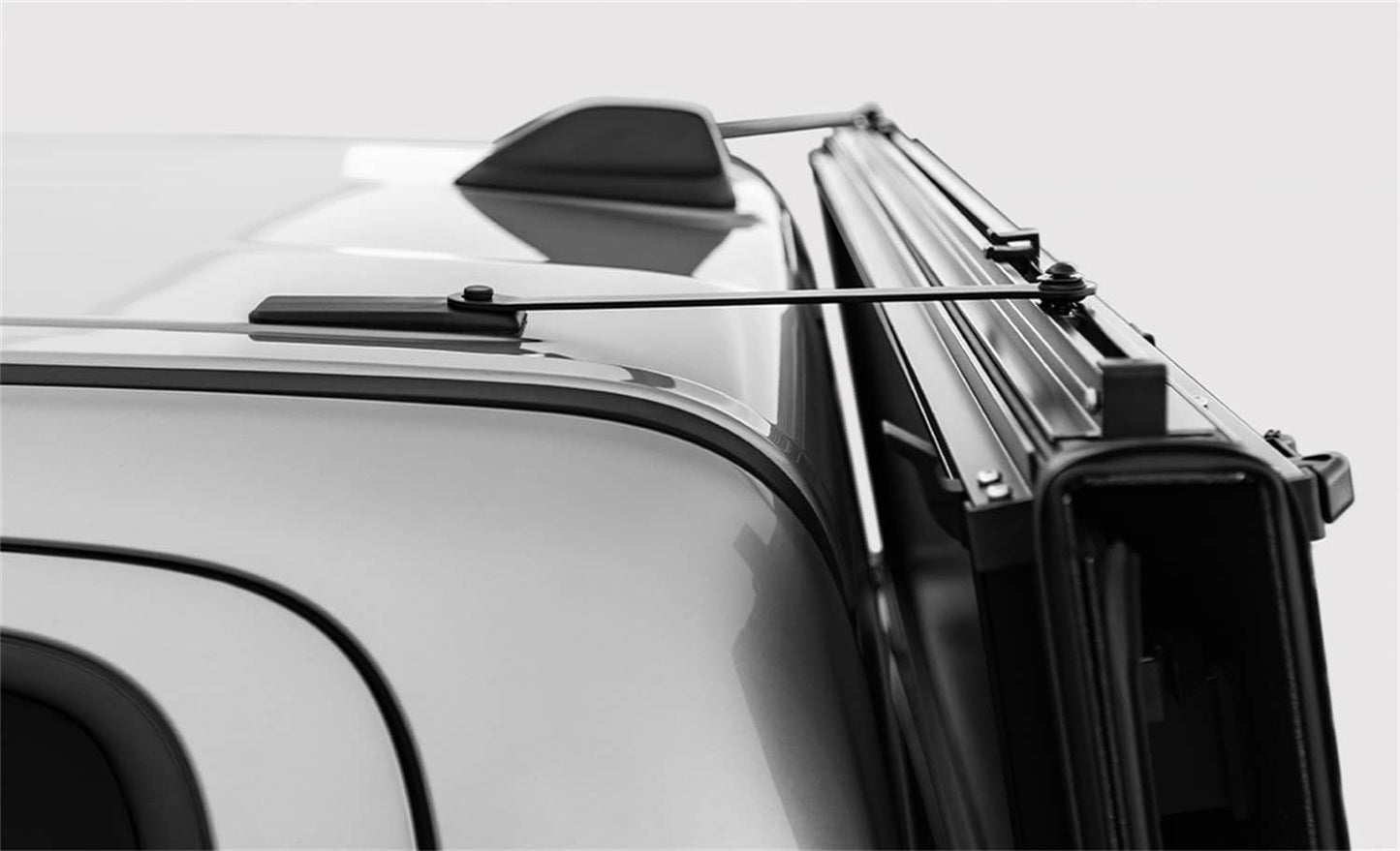 A Jeep Gladiator with the LOMAX STANCE hard folding tonneau cover installed, showing the black urethane finish and Trail Rail system.