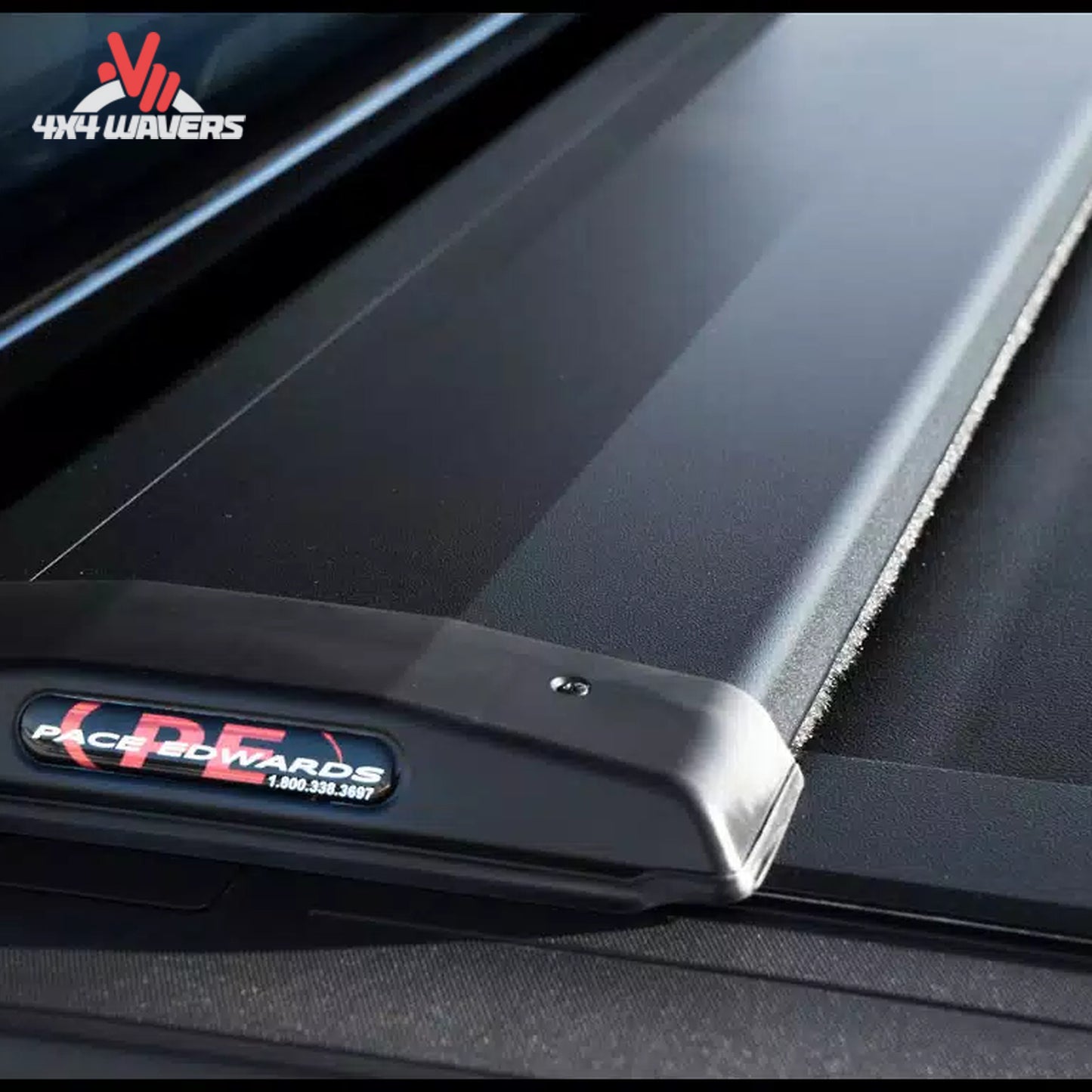 Pace Edwards Switchblade hard retractable tonneau cover on 97-14 Ford F-150 6.5' bed, close-up of quick-release canister mechanism