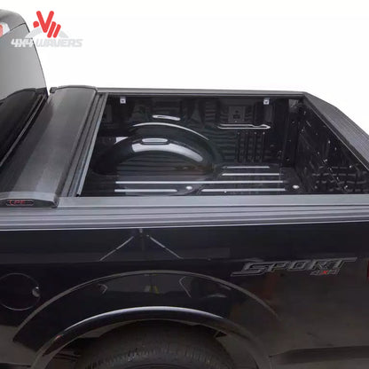 Close-up of Pace Edwards Switchblade hard retractable tonneau cover canister on a 97-14 Ford F-150 with 6.5-foot bed, showing quick-release mechanism.