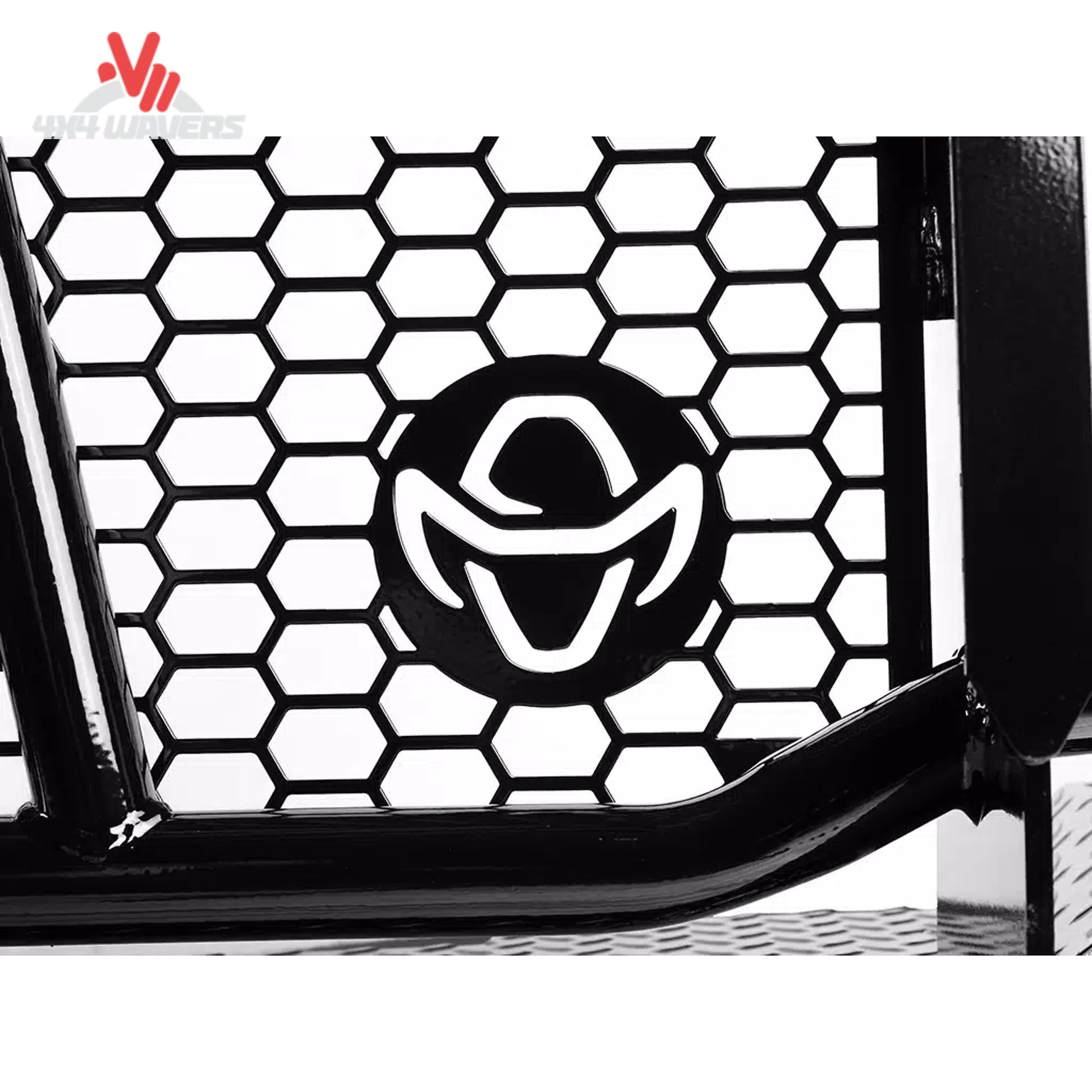 Close-up of a black metal bull bar or grille component with a honeycomb pattern and a circular black-and-white logo badge, shown against a white background.