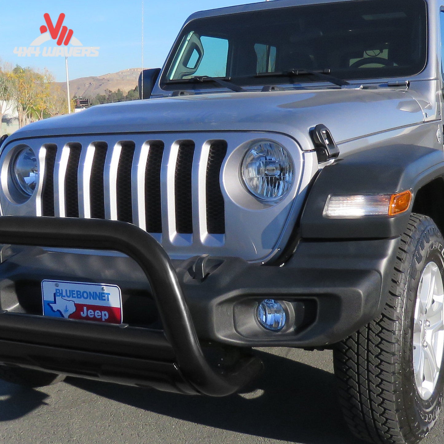 Jeep Wrangler JL equipped with Rugged Ridge front bull bar and skid plate; How does a Rugged Ridge bull bar improve front-end protection on a Jeep Wrangler JL?