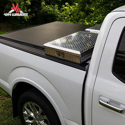 A soft roll up vinyl tonneau cover mounted behind a crossover toolbox on a 6.5 foot standard box Ford F-150 SKU BGPC_61379.