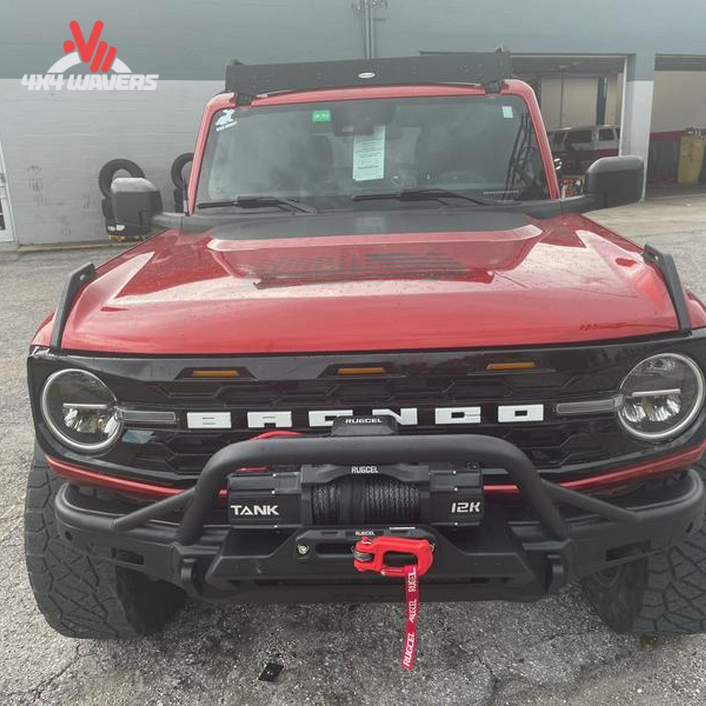 Full-width Smittybilt Bronco bumper featuring recovery points, bull bar protection, and auxiliary light mounts