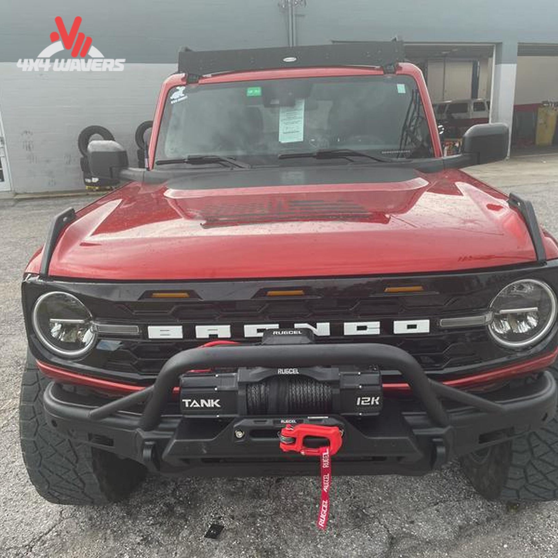 Full-width Smittybilt Bronco bumper featuring recovery points, bull bar protection, and auxiliary light mounts