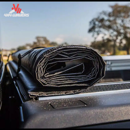 TonnoSport roll up bed cover 22010369 rolled forward to cab with storage straps SKU BGPC_22010369.