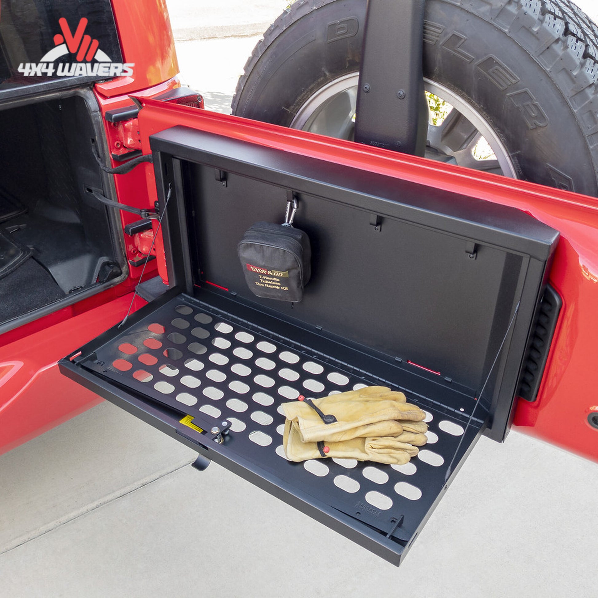 Open MOLLE tailgate lockbox showing secure storage area and removable organization trays