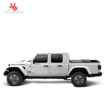 Matte black UnderCover Ultra Flex truck bed cover protecting cargo on a Jeep Gladiator JT pickup truck