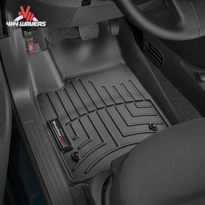 Driver and passenger footwell protected by WeatherTech all-weather floor mats inside a Jeep Wrangler JK