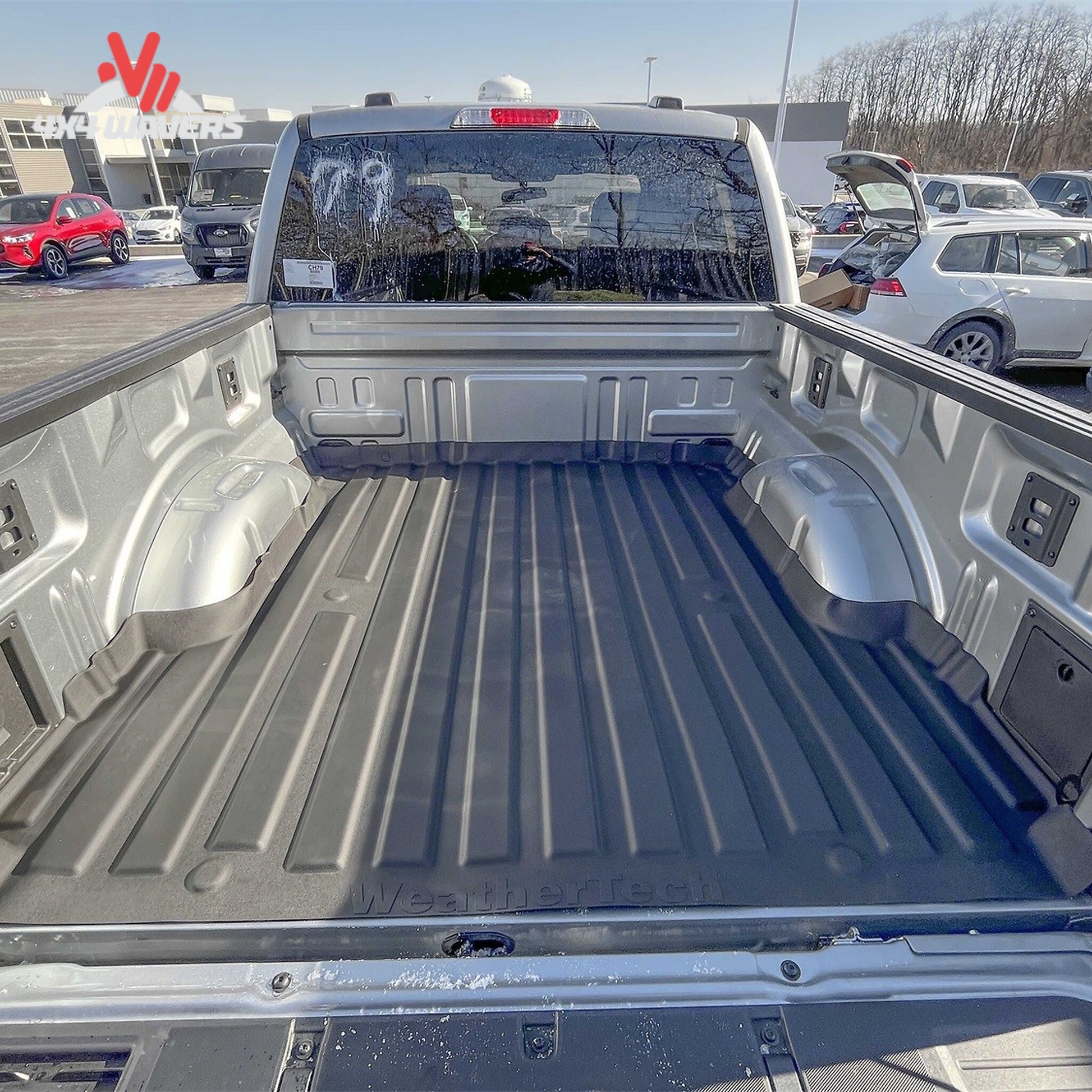 Top angle view of Ford F150 truck bed with installed black WeatherTech ImpactLiner mat 36927IM