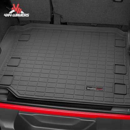 Jeep Wrangler JL Unlimited cargo compartment protected by a WeatherTech cargo liner designed for factory subwoofer applications