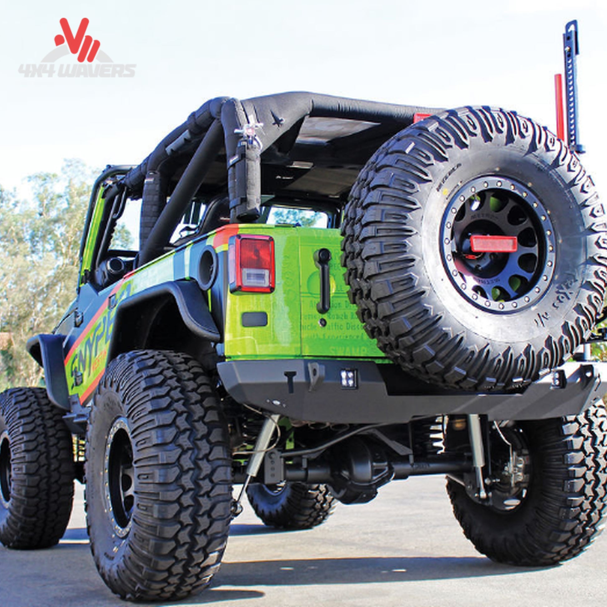 Close-up of the reinforced swing-out tire carrier supporting oversized off-road spare tires
